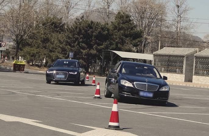 Security drivers practicing evasive driving on a cone course